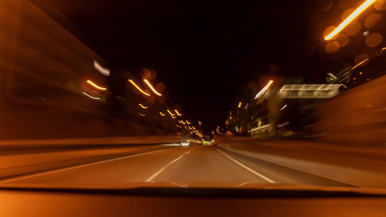 Hyperlapse of a tunnel drive with a car, front view through the windshield with speed blurry effects