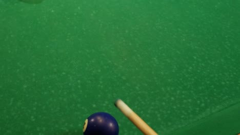 pool cue and balls on green table