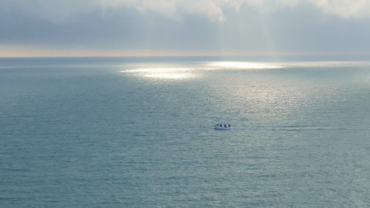 fishing boat sailing home late afternoon calm seas Sundays on water Copper coast Waterford Irish coastline fishing industry