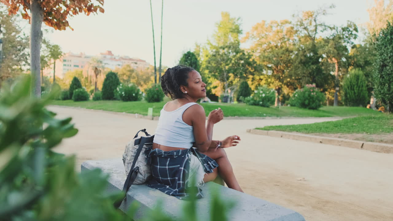 A woman sitting on a bench in a park