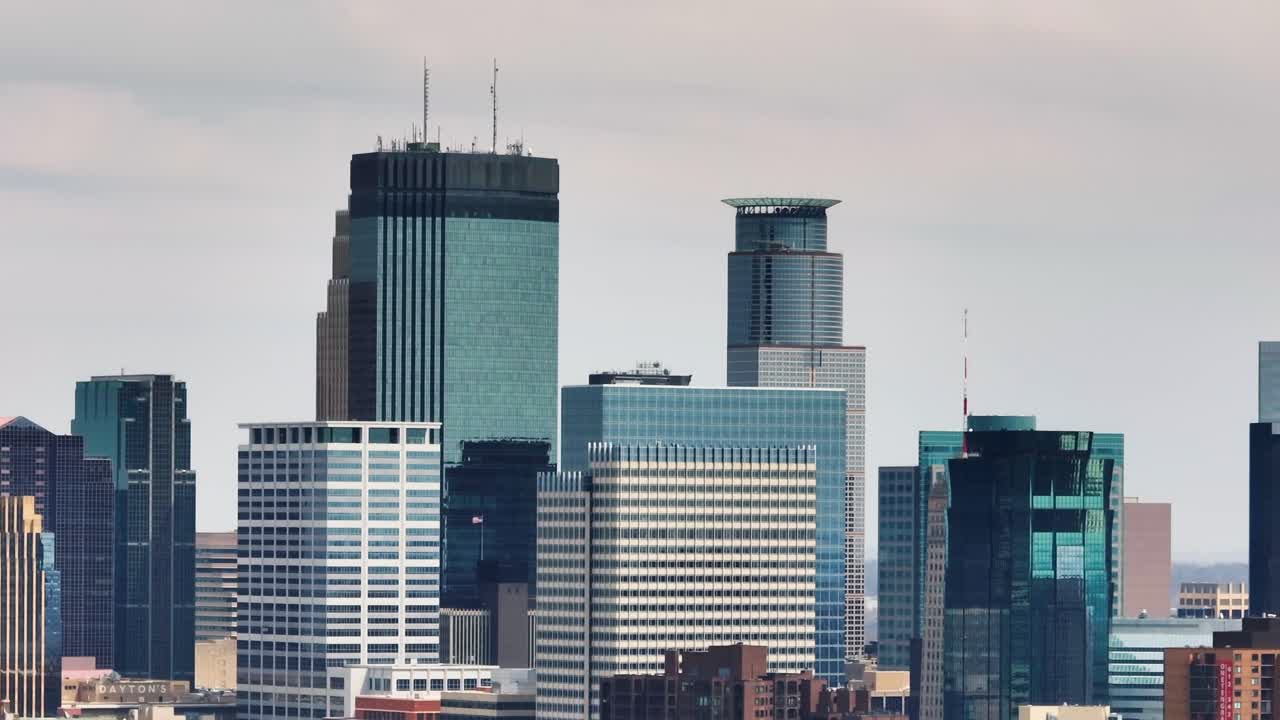 Tight telephoto aerial drone view of the Minneapolis skyline showing modern high-rises and glass architecture
