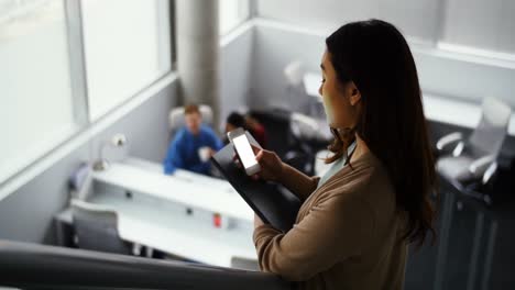 female executive using mobile phone