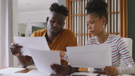 video of focused african american couple planning home budget