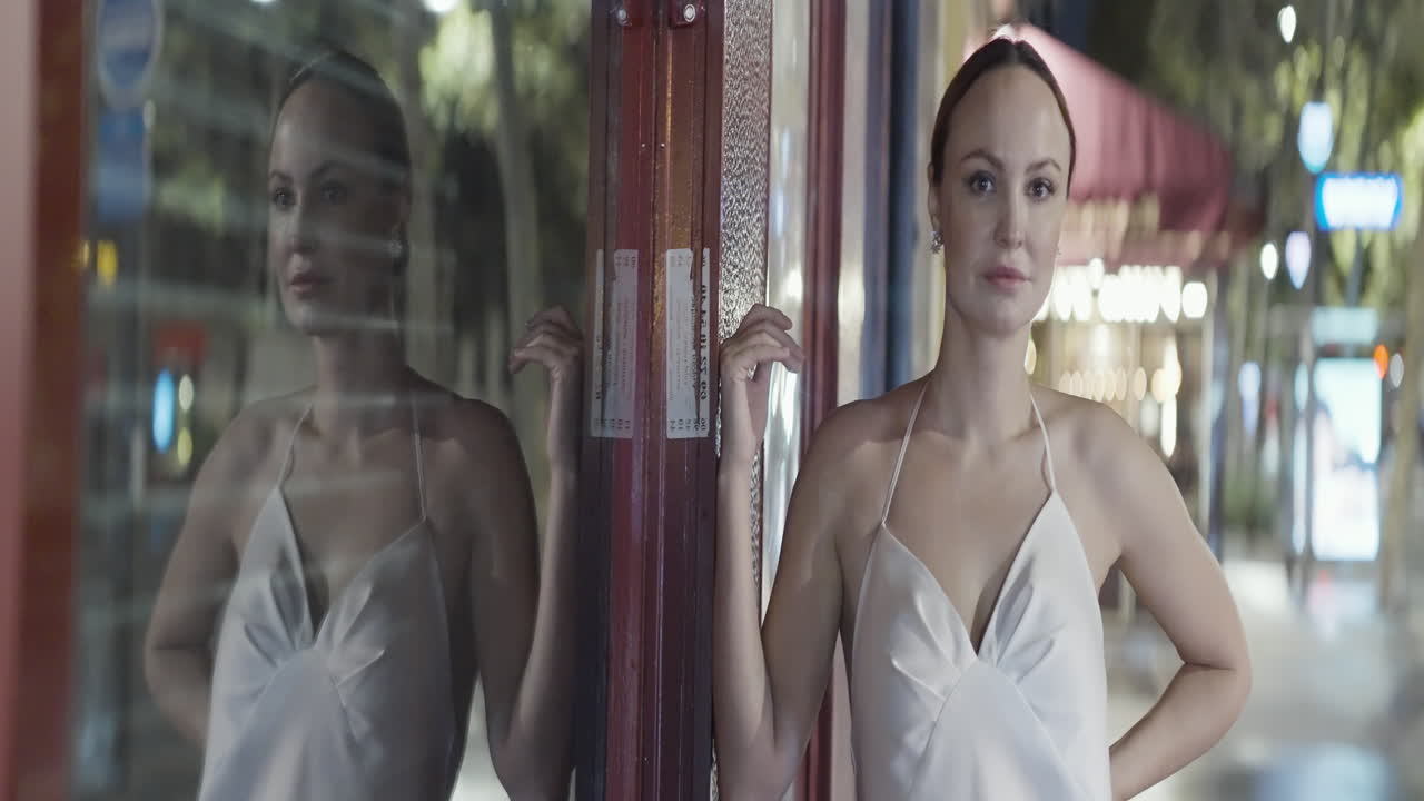 Woman in a white dress at night