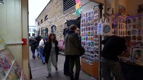 tourists explore camden market in london browsing colorful souvenir stalls on a busy day