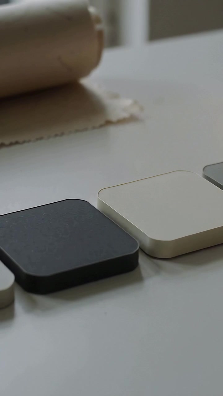 Vertical video: Rolling roller moving on cloth on table, centering dark sample among three samples