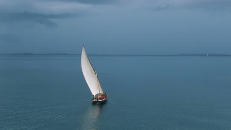 Aerial-of-dark-clouds-and-lonely-boat-in-the-ocean