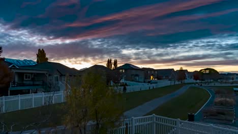 Morning-sunrise-over-a-suburban-neighborhood-with-stunning-colors-as-waves-of-clouds-pass-overhead---static-time-lapse