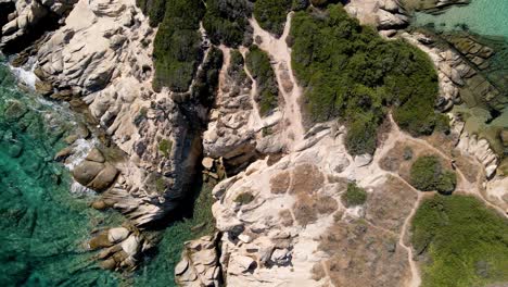 Aerial-drone-clip-over-a-rock-formation-in-an-exotic-beach-in-Vourvourou,-Chalkidiki,-Greece