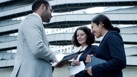 cheerful business people discussing papers