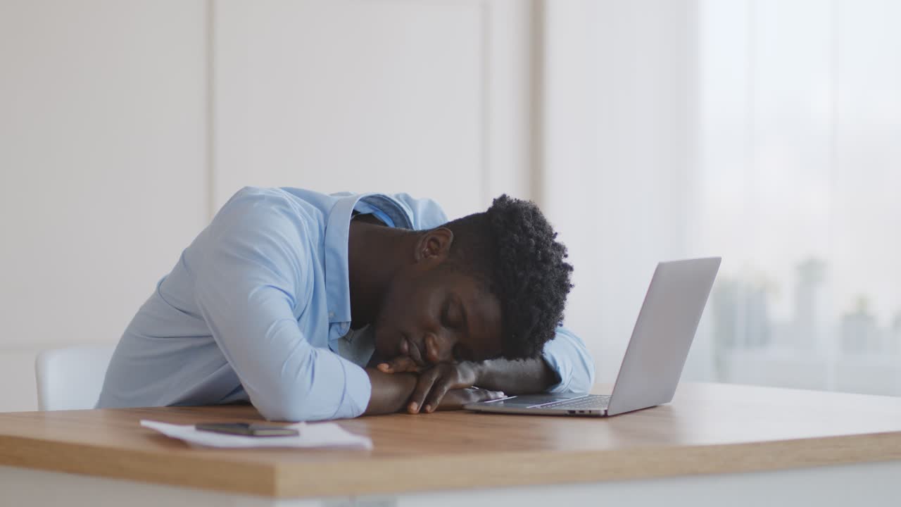 Tired Man Sleeping at His Laptop