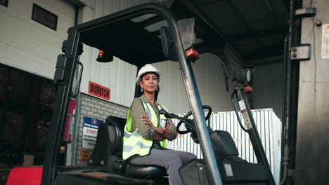 female worker on a forklift in a warehouse