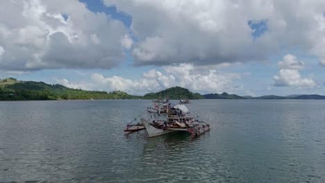 Large-fishing-boats-in-the-seas-of-Surigao-del-Norte-in-the-Caraga-region-of-Mindanao,-Philippines-aerial-orbital