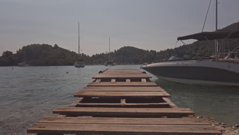 wooden gang plank on beach in nydri port, lefkada greece