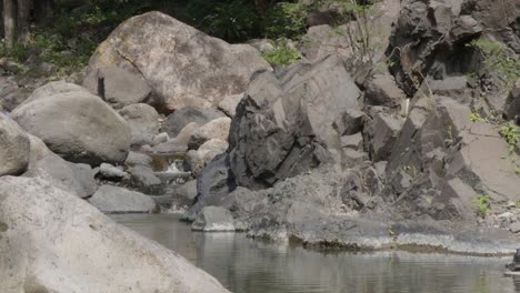 Small-river-that-flows-gently-between-large-rock-formations-during-the-summer-in-the-town-of-the-municipality-of-Soledad-in-Honduras