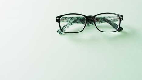 Video-of-a-pair-of-glasses-on-green-background-with-copy-space