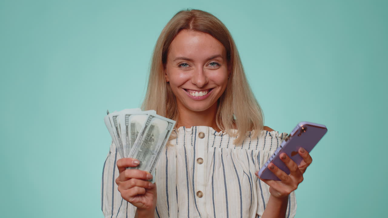 Happy tourist woman use smartphone rejoicing win, receiving money dollar cash, success lottery luck