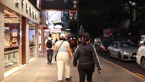 people walking on a busy hong kong street