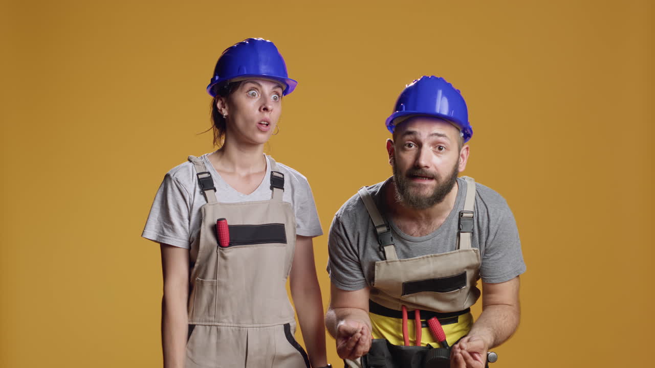 Portrait of construction workers having argument in studio