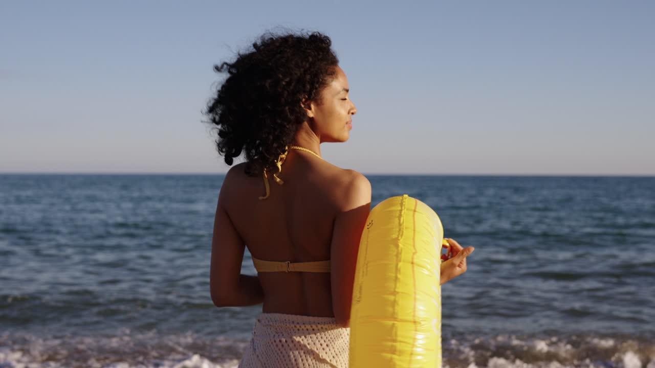 Donna con salvagente gonfiabile sulla spiaggia