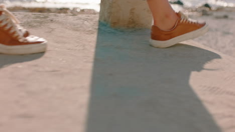 close up feet woman walking down steps on beach enjoying warm sunny day carefree girl exploring summer vacation lifestyle