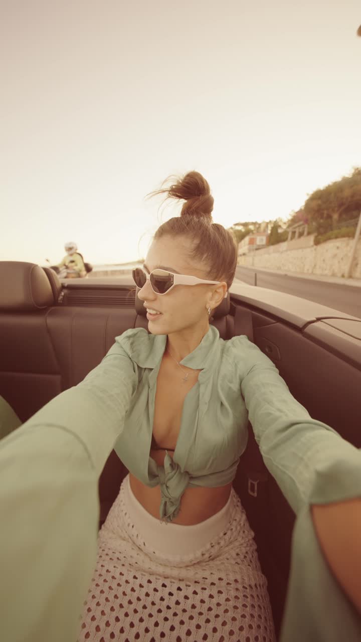 Woman in a convertible on a road trip