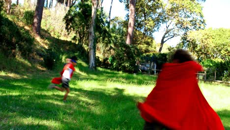 Friends-pretending-to-be-a-superhero-in-park