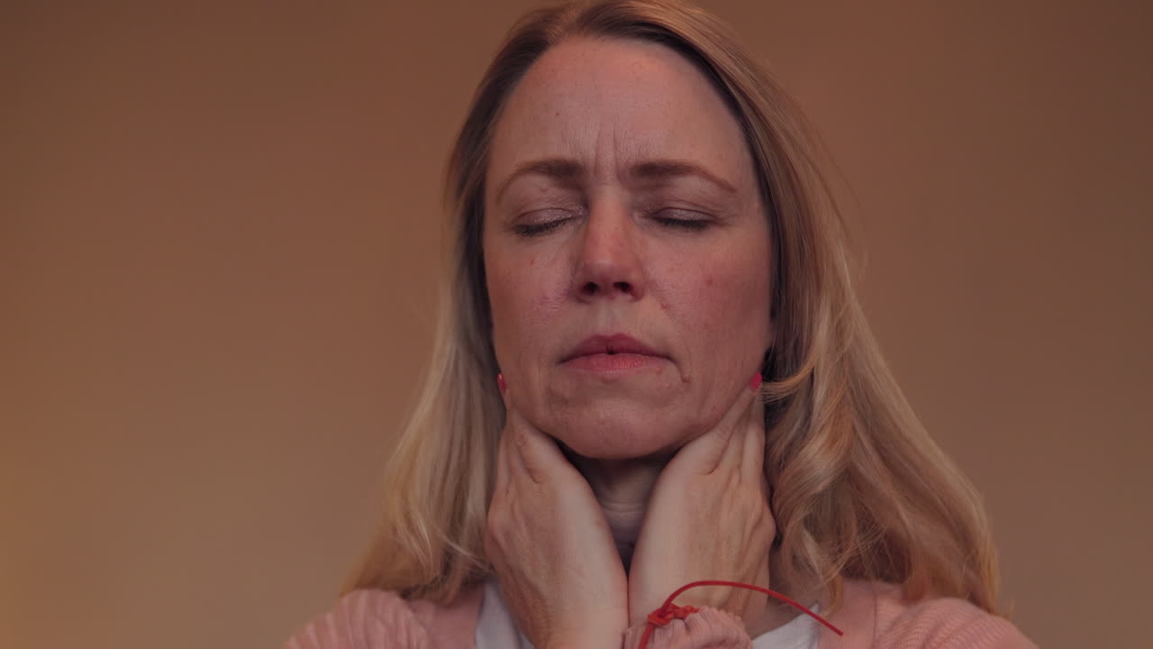 Woman checking her thyroid