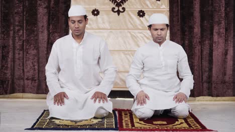 muslim men praying to allah at home