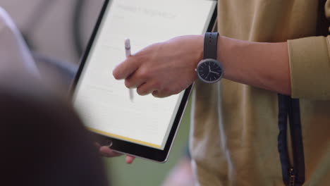 young business people meeting businessman hands presenting financial data using tablet computer showing diverse colleagues marketing ideas in office boardroom close up