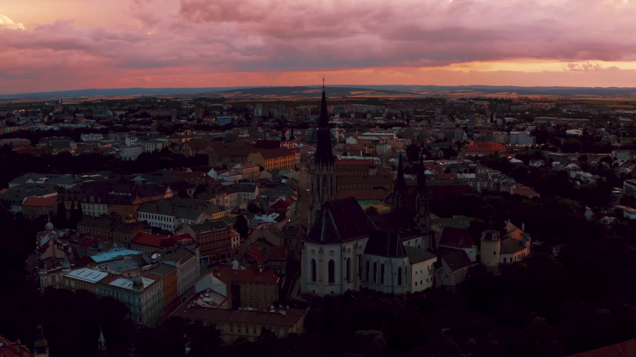 Red Church And The City Landscape During Golden Sunset At Olomouc, Czech Republic. aerial