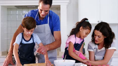 happy family preparing cookies in kitchen