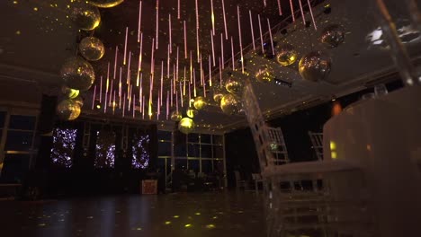dim venue with floral wedding decor and candlelight casting warm glows on tables