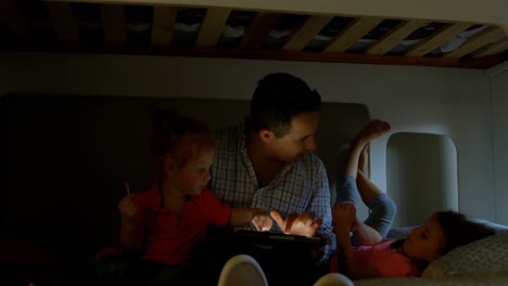 father and children using digital tablet in bedroom at home 4k