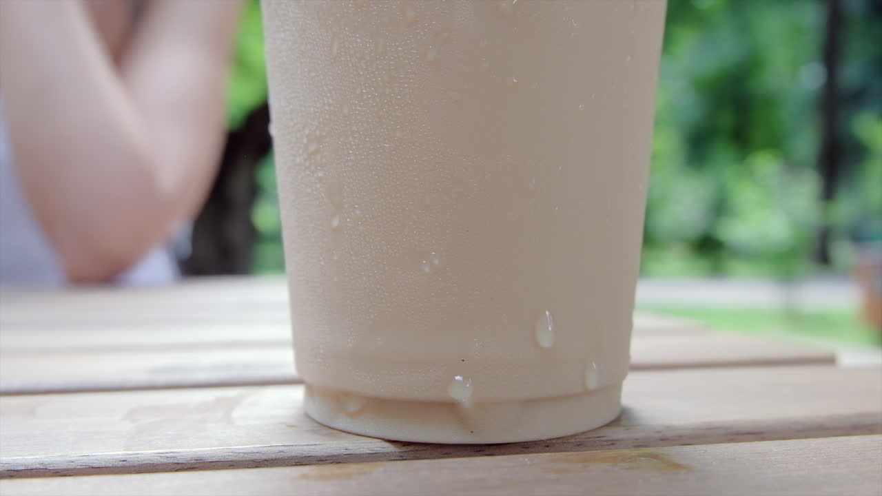 Close up of an iced latte on a table at a terrace