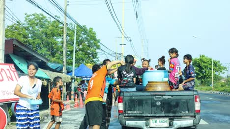 people joyfully splashing water during a festival