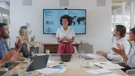 group-of-business-people-celebrating-in-boardroom-meeting-with-happy-team-leader-woman-sharing-successful-financial-report-clapping-hands-applause-in-office