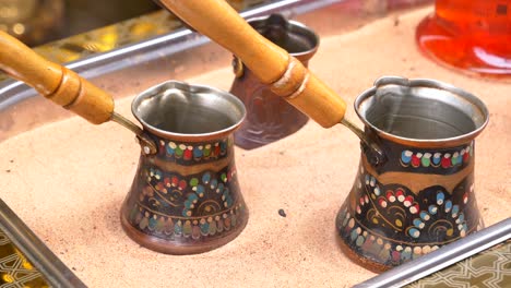 close-up of a traditional turkish coffee pot on sand