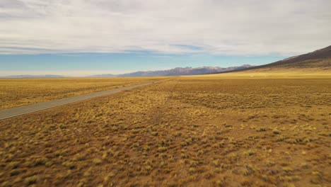 Car-Driving-On-Mountain-Valley-Dirt-Road-Fly-Over-Aerial-Shot-4K