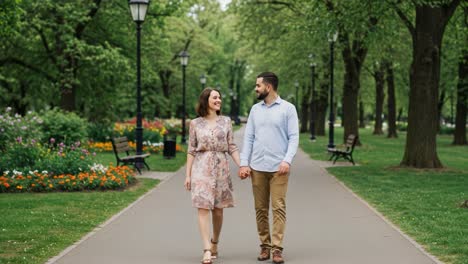 a romantic stroll through a lush park pathway, embracing nature and each other in a charming outdoor setting, capturing love and togetherness