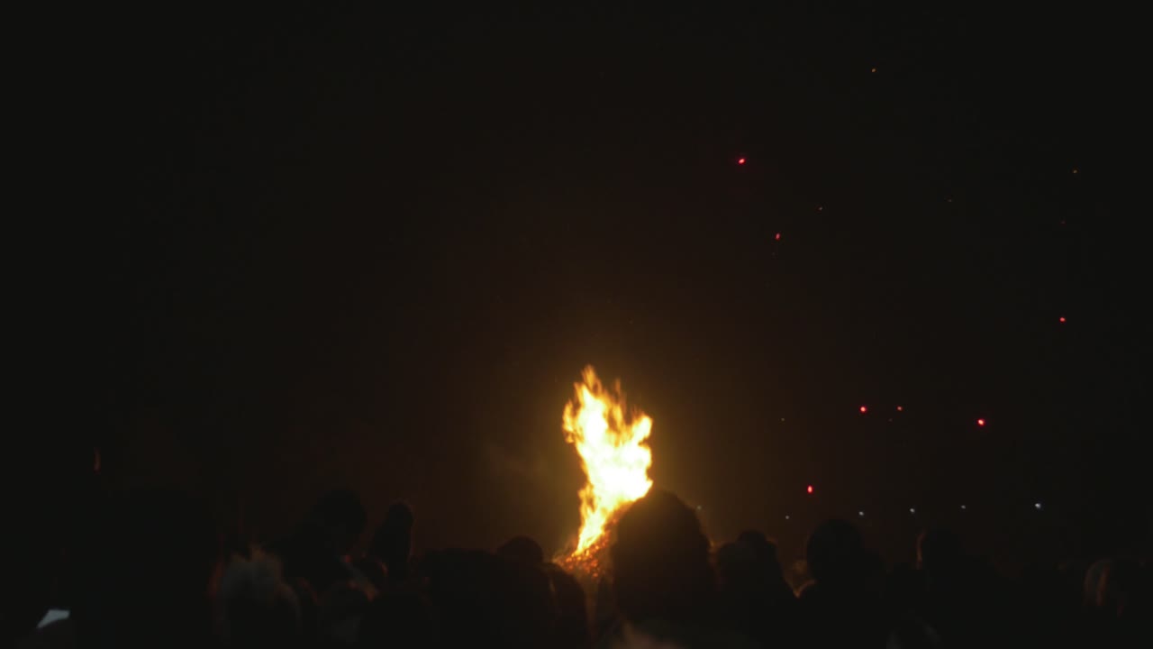 Fireworks exploding over heads of crowd