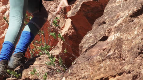 adventurers going up on sandstone cliff before rappel