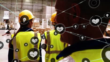 animation of network of connections with icons over diverse workers walking in warehouse