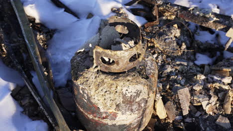 burned and destroyed metal gas propane tank disaster rubble after lousville superior colorado marshall fire