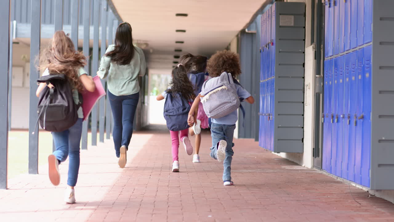 Running down school hallway, children with backpacks heading to class