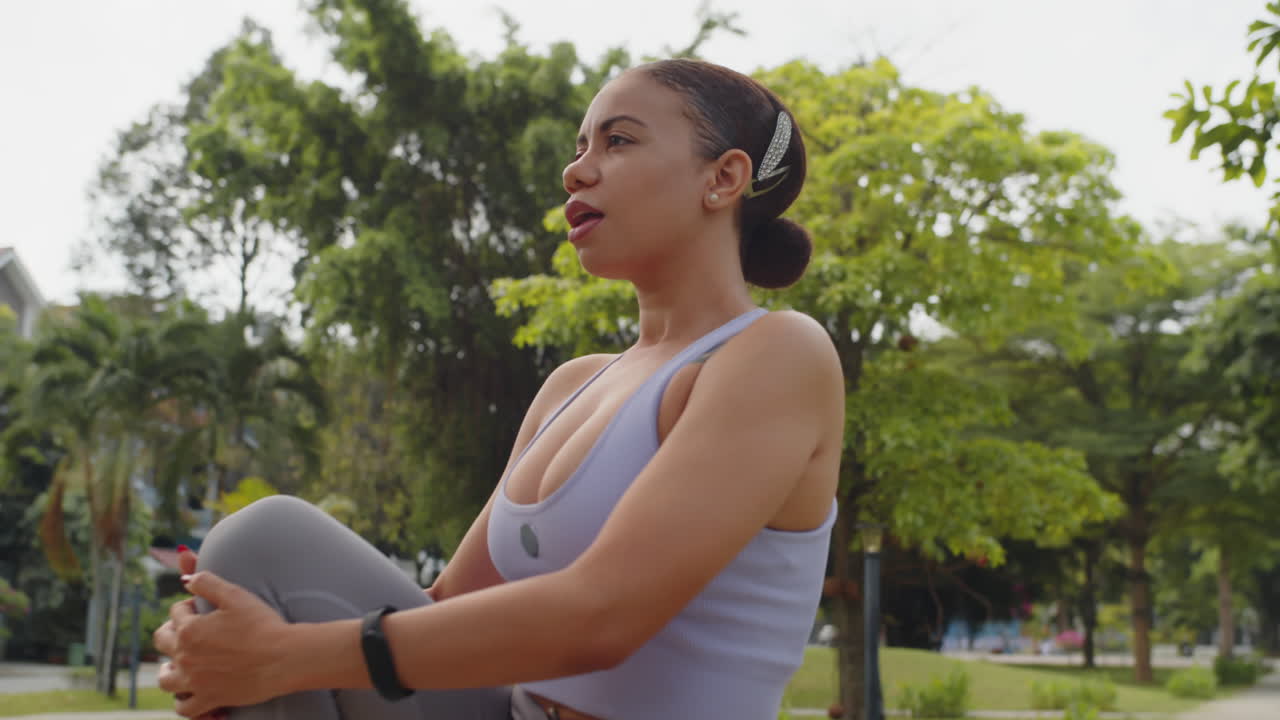 Latin Girl Stretching Leg Muscles during Workout in City Park