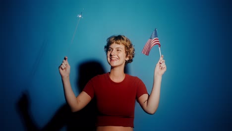 woman celebrating with an american flag and sparkler