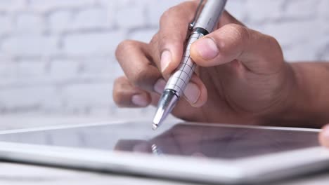 person using a tablet with a stylus