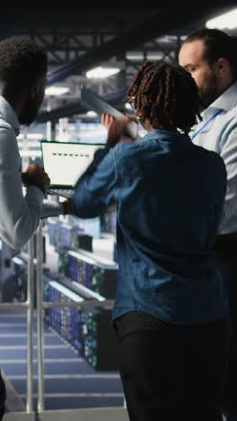 Vertical video Worried workers trying to fix hacked infrastructure systems