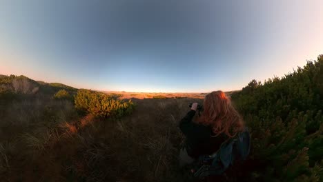 a red-haired man takes pictures of songbirds on bandon beach